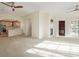 Bright living room featuring a fireplace, kitchen, and hardwood flooring at 290 Poplar St # A, Denver, CO 80220