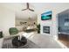 Bright living room with a view into the dining room and a white fireplace at 290 Poplar St # A, Denver, CO 80220