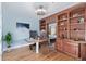 Bright office featuring built in shelving, a desk and a light blue wall at 290 Poplar St # A, Denver, CO 80220