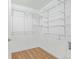 Walk-in closet with white wire shelving and wood look flooring at 290 Poplar St # A, Denver, CO 80220