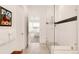Bright bathroom featuring a glass shower and decor, open to the main bedroom at 22364 E Bailey Pl, Aurora, CO 80016