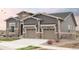 Beautiful two-story home featuring a two-car garage and stone and gray siding at 22364 E Bailey Pl, Aurora, CO 80016