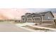 A beautiful two-story home with stone facade, gray siding, and a spacious two-car garage and community view at 22364 E Bailey Pl, Aurora, CO 80016