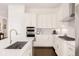 Updated kitchen with modern appliances, white cabinets, and spacious island at 22364 E Bailey Pl, Aurora, CO 80016