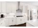 Bright kitchen with white cabinetry, stainless steel appliances, and sleek countertops at 22364 E Bailey Pl, Aurora, CO 80016
