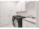 Functional laundry room with modern washer and dryer at 22364 E Bailey Pl, Aurora, CO 80016