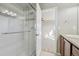 Bathroom with glass-enclosed shower and a view into the bedroom, blending style with practicality at 1601 Venice Ln, Longmont, CO 80503