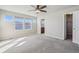 Bright bedroom features multiple windows, neutral walls, plush carpet, and an en-suite bathroom at 1601 Venice Ln, Longmont, CO 80503