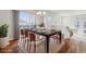 Elegant dining room features a large wooden table, seating for eight, and sliding glass doors to a patio at 1601 Venice Ln, Longmont, CO 80503