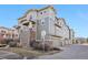 Exterior view of multi-level townhomes with stone accents, neutral siding, attached garages and well-manicured landscaping at 1601 Venice Ln, Longmont, CO 80503