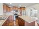 Modern kitchen with stainless steel appliances, a center island, tile backsplash and wood floors at 1601 Venice Ln, Longmont, CO 80503