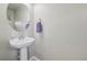 Elegant powder room with a pedestal sink and decorative mirror at 1601 Venice Ln, Longmont, CO 80503