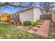 The backyard features a deck, stairs, and a landscaped area with steps leading to a wooden gate at 11203 W Dorado Ave, Littleton, CO 80127