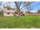 Exterior view of the home's backyard and deck surrounded by trees and green space at 11203 W Dorado Ave, Littleton, CO 80127