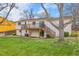 Exterior view of the home, featuring a two-level deck and a well-manicured lawn at 11203 W Dorado Ave, Littleton, CO 80127