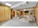 Finished basement with a stone fireplace, plush seating, and wood-paneled walls at 11203 W Dorado Ave, Littleton, CO 80127