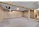 Unfinished basement with wood paneling, carpet and drop ceiling at 11203 W Dorado Ave, Littleton, CO 80127