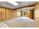 Finished basement with wood paneling, carpet flooring and backyard access at 11203 W Dorado Ave, Littleton, CO 80127