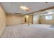 Unfinished basement space with retro wood paneling, drop ceiling, and large windows at 11203 W Dorado Ave, Littleton, CO 80127
