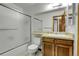 Bathroom features shower over tub, wood vanity, and tile floor at 11203 W Dorado Ave, Littleton, CO 80127
