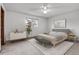 Serene bedroom with a neutral palette, soft carpet, and a large window offering natural light at 11203 W Dorado Ave, Littleton, CO 80127