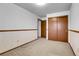 Bedroom with neutral walls and carpet has wood paneling and closet at 11203 W Dorado Ave, Littleton, CO 80127