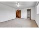 Bright bedroom features neutral carpet, ceiling fan, and closet for ample storage at 11203 W Dorado Ave, Littleton, CO 80127