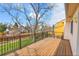 An outdoor deck with metal railings provides a view of the backyard and surrounding greenery at 11203 W Dorado Ave, Littleton, CO 80127