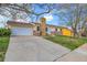 Charming home featuring a stone chimney and a large driveway, providing ample parking space at 11203 W Dorado Ave, Littleton, CO 80127