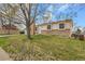 Lovely single-story house with a well-maintained lawn, mature tree and a brick and siding exterior at 11203 W Dorado Ave, Littleton, CO 80127