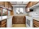 Spacious kitchen with wood cabinetry, laminate countertops, white appliances and a window overlooking the backyard at 11203 W Dorado Ave, Littleton, CO 80127