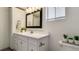 Bright bathroom showcasing a stylish vanity, good light and a functional toilet at 1525 S Holly St # 106, Denver, CO 80222