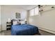 Cozy bedroom with natural light and decorative shelving, creating a stylish retreat at 1525 S Holly St # 106, Denver, CO 80222