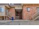 Exterior shot of a brick building with exterior stairs and visible unit numbers at 1525 S Holly St # 106, Denver, CO 80222