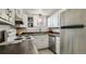 Practical kitchen features white cabinetry, stainless steel appliances, and ample countertop space at 1525 S Holly St # 106, Denver, CO 80222
