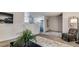 Open living space with neutral tones and decorative plant, open to the kitchen area at 1525 S Holly St # 106, Denver, CO 80222