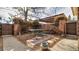 Brick-paved patio with a picnic table and grill, surrounded by greenery and a privacy fence at 1525 S Holly St # 106, Denver, CO 80222