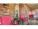 Cozy outdoor patio space with red chairs and a small table, perfect for relaxing at 1525 S Holly St # 106, Denver, CO 80222