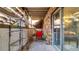 Relaxing patio with brick wall, exposed beams, sliding glass door and comfortable red chairs at 1525 S Holly St # 106, Denver, CO 80222