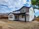 View of the back of the house with patio and wooden fence at 5550 Wetlands Dr, Longmont, CO 80504