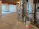 Unfinished basement with concrete floor, exposed ductwork, a furnace and hot water heater at 5550 Wetlands Dr, Longmont, CO 80504