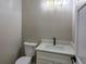 This half-bathroom features a modern vanity with quartz countertop and sleek black faucet at 5550 Wetlands Dr, Longmont, CO 80504