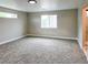 Large bedroom with carpeted floors, a window, and neutral paint, illuminated with recessed lighting at 5550 Wetlands Dr, Longmont, CO 80504