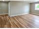 A large bedroom has wood floors, neutral walls, and a window that provides natural light at 5550 Wetlands Dr, Longmont, CO 80504