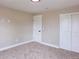 Empty bedroom features neutral walls, carpet, door, and closet with sliding doors at 5550 Wetlands Dr, Longmont, CO 80504