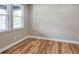 Sun-filled bedroom featuring wood floors, neutral paint and bright white trim at 5550 Wetlands Dr, Longmont, CO 80504
