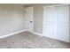 Bedroom with neutral carpet and walls, recessed lighting, closet with sliding doors and door at 5550 Wetlands Dr, Longmont, CO 80504
