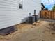 View of the side of the house with two AC units and a window well at 5550 Wetlands Dr, Longmont, CO 80504