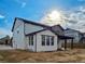Exterior view of the back of the home, showcasing the patio and attached garage at 5550 Wetlands Dr, Longmont, CO 80504