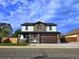 Two-story home with a modern garage door and a stone-accented porch at 5550 Wetlands Dr, Longmont, CO 80504